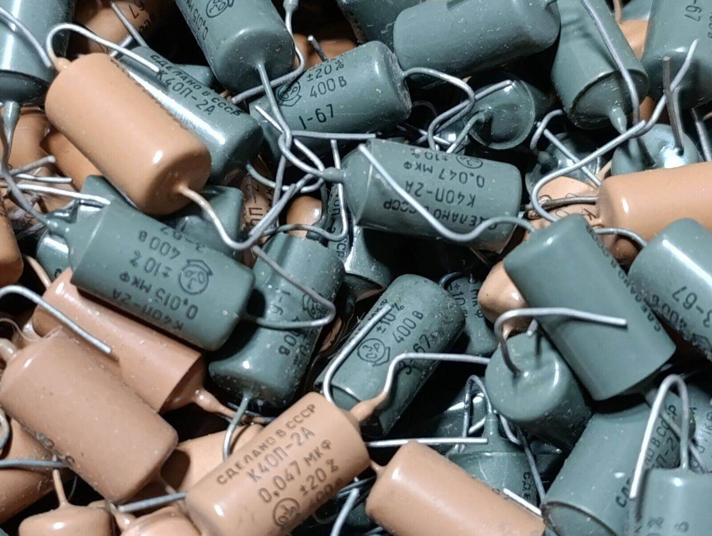 Collection of K40P-2A PiO AUDIO guitar tone capacitors in grey and beige, showcasing vintage electronics components.