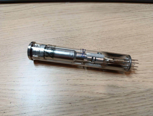 Vintage Russian Vidicon tube LI422-2 on wooden surface showcasing its metallic design and pins for electronic applications.